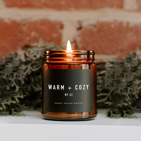 Sweet Water Decor Warm and Cozy Candle | Pine, Orange, Cinnamon, and Fir Balsam Winter Scented Soy Candles for Home | 9oz Amber Jar with Black Lid, 40 Hour Burn Time, Made in the USA