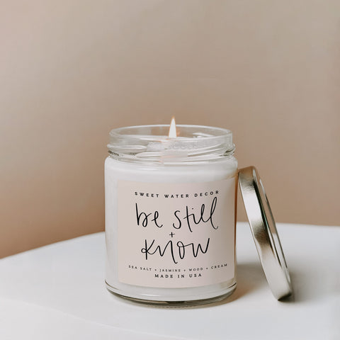 Sweet Water Decor, Be Still and Know, Sea Salt, Jasmine, Cream, and Wood Scented Soy Wax Candle for Home | 9oz Clear Jar, 40 Hour Burn Time, Made in the USA